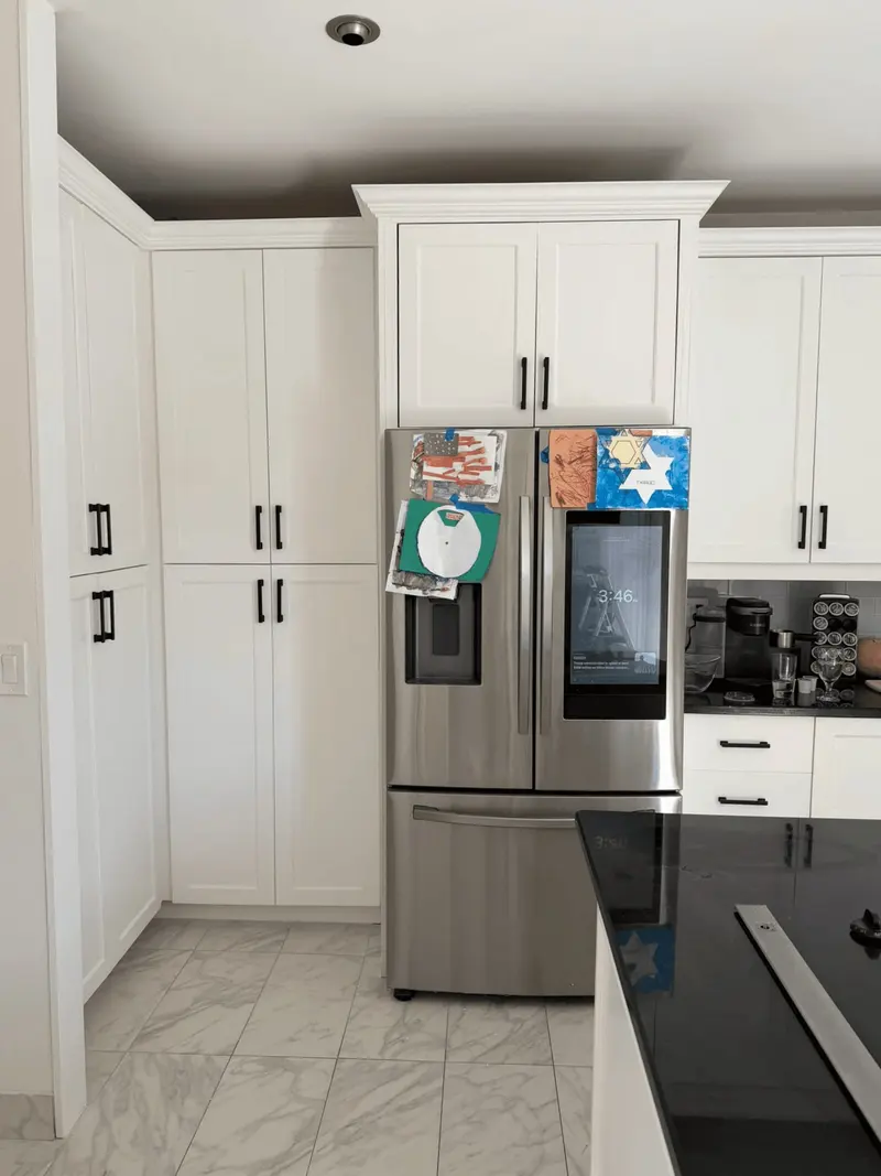 After: tall white pantry cabinets beside the refrigerator, Hallandale Beach