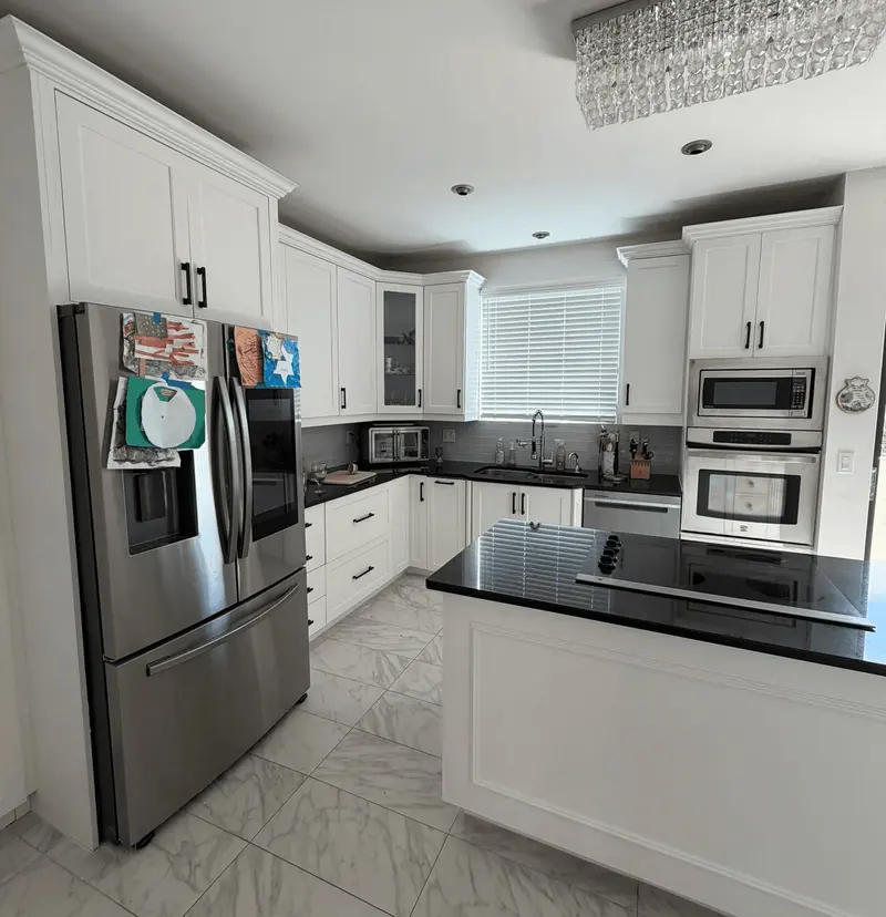 After: wide view of the refinished white kitchen with double wall oven, Hallandale Beach