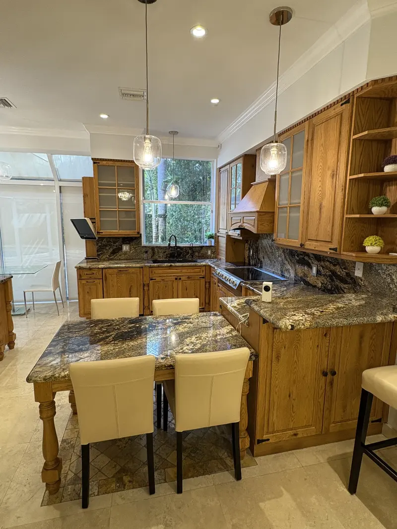 Aventura kitchen before painting, oak cabinets with the dining area in view