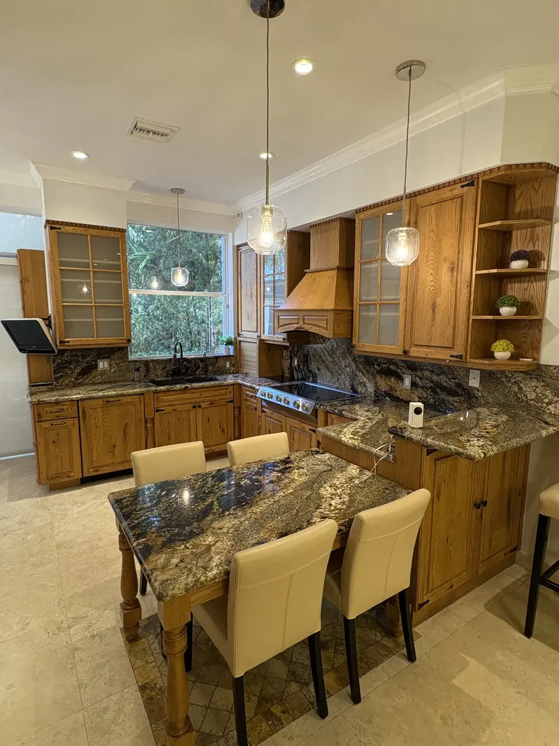 Aventura kitchen before painting, with oak cabinets and granite countertops
