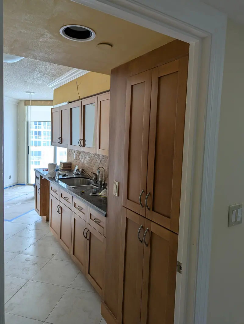 Before painting: wood pantry cabinets and galley kitchen, Sunny Isles Beach