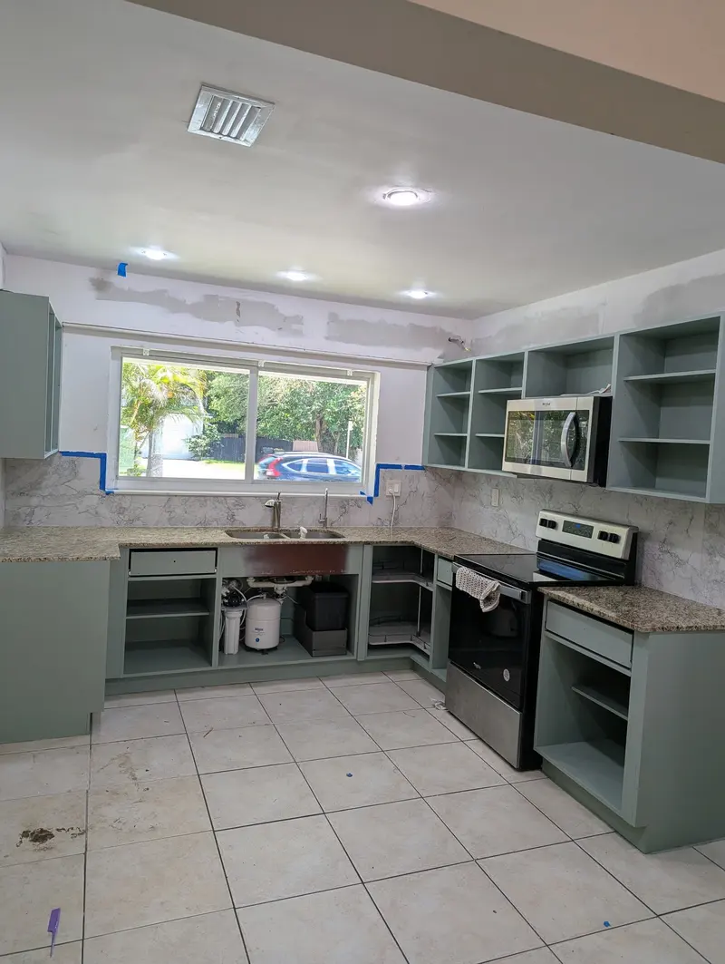 Cabinet boxes refinished in gray-green with doors removed, North Miami