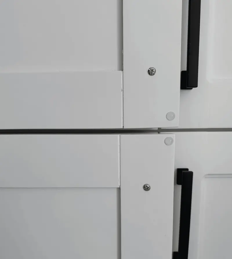 Detail of refinished white shaker doors and hardware
