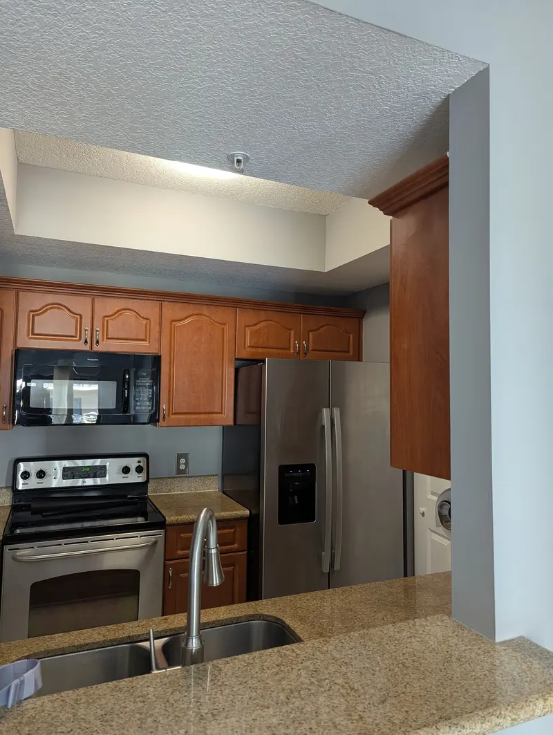 Expert cabinet painting that refreshes this kitchen with a brighter, modern look and a smooth, high-quality finish.
