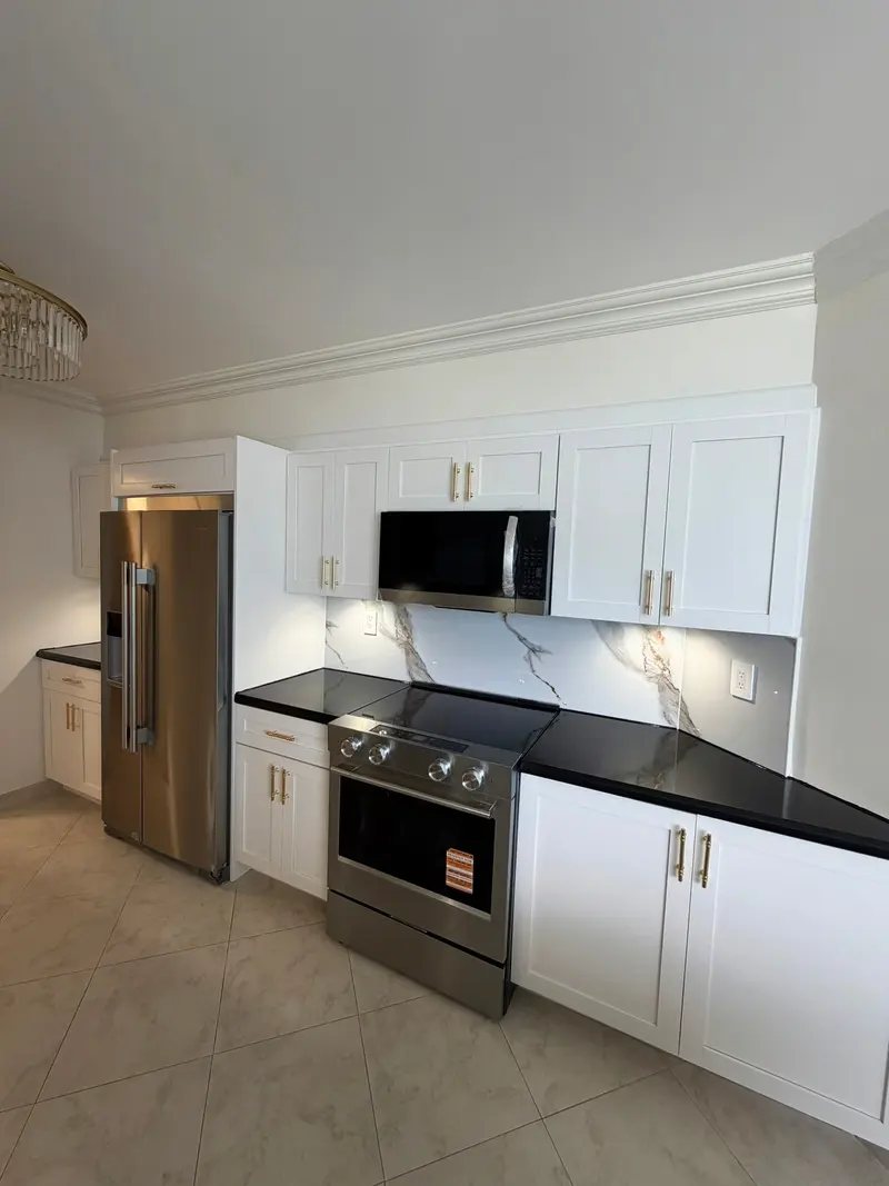 Finished white shaker cabinets with black countertops and stainless appliances, Sunny Isles Beach