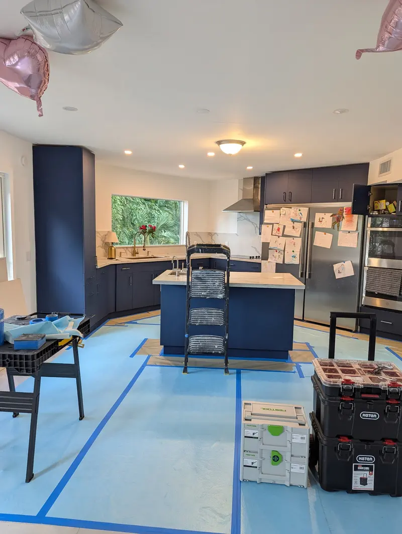 Here we continue protecting and preparing the floors as we begin the cabinet painting process