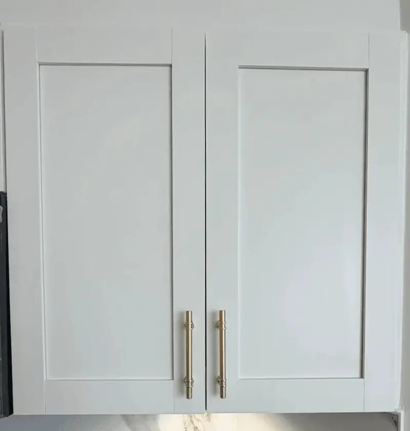 The same shaker cabinet doors after painting in white Alabaster with gold pulls
