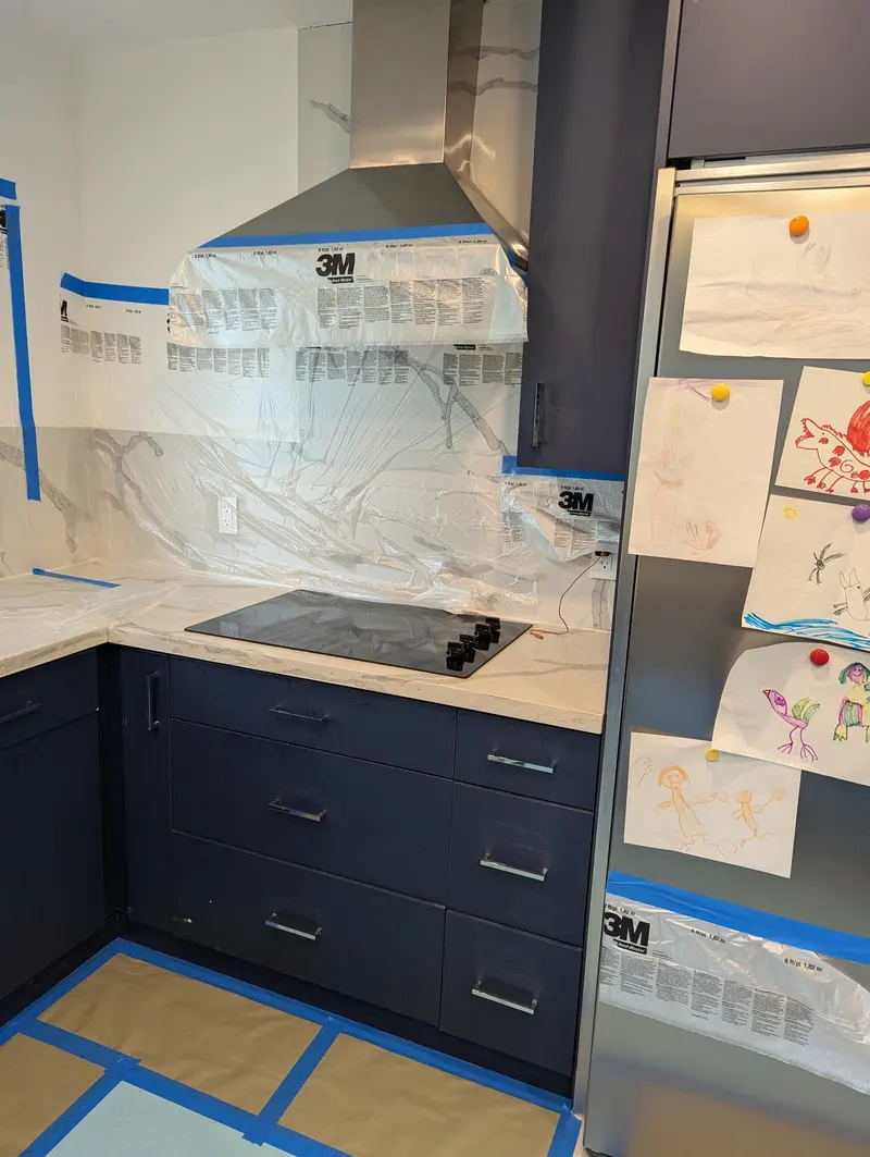 Navy cabinets and range area prepped and masked in the Fort Lauderdale kitchen