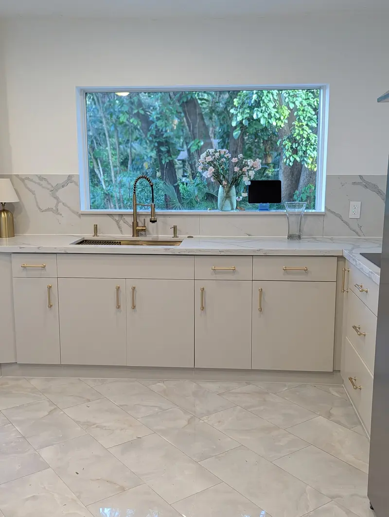 Refinished beige lower cabinets with marble backsplash in the Fort Lauderdale kitchen