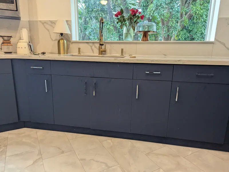 This photo shows the cabinets before painting, with visible damage caused by kitchen grease on the surface. With the proper preparation and professional process, we can restore your kitchen without the need for a full replacement-saving you hundreds of dollars.