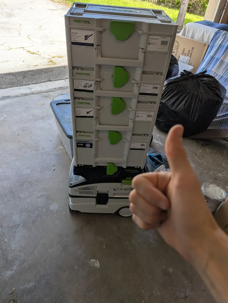 Thumbs-up next to dust-extraction equipment on the job site